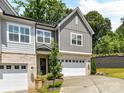 Charming two-story home with gray siding, brick accents, a two-car garage, and a well-manicured front yard at 3135 Everly Enclave Way, Charlotte, NC 28210