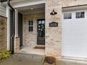 Close-up of front door with brick facade and wreath, showing house number 3135 at 3135 Everly Enclave Way, Charlotte, NC 28210