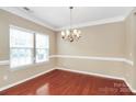 Formal dining room with hardwood floors, large windows and stylish chandelier at 3251 Park South Station Blvd, Charlotte, NC 28210
