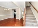 Inviting dining room featuring hardwood floors, staircase, and elegant lighting at 3251 Park South Station Blvd, Charlotte, NC 28210