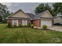 Well-maintained brick home with a two-car garage and lush green lawn at 330 Kilmer Ln, Mooresville, NC 28115