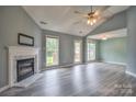 Bright living room featuring a fireplace, ceiling fan, and multiple windows at 330 Kilmer Ln, Mooresville, NC 28115