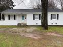 Charming white-brick ranch home featuring black shutters, covered porch, and a well-maintained front yard at 3701 Tipperary Pl, Charlotte, NC 28215