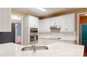 Well-lit kitchen showcasing white cabinets, stainless steel appliances, and a practical breakfast bar area at 4066 Belle Meade Cir, Belmont, NC 28012