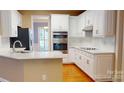Bright kitchen featuring white cabinets, stainless steel appliances, and a breakfast bar, perfect for modern living at 4066 Belle Meade Cir, Belmont, NC 28012