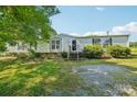 Well-maintained home with green lawn and mature trees on a sunny day at 4122 Canal Rd, Marshville, NC 28103