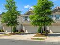 Well-manicured townhome exterior showcasing a two-car garage, neat landscaping, and inviting curb appeal at 415 Tayberry Ln, Fort Mill, SC 29715