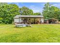 Expansive backyard featuring a covered deck, above ground pool and space for outdoor activities at 4155 Slanting Bridge Rd, Sherrills Ford, NC 28673
