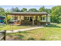 Charming home with a covered front porch, offering a welcoming entrance and outdoor living space at 4155 Slanting Bridge Rd, Sherrills Ford, NC 28673