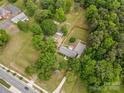An aerial view showcases the property's layout, mature trees, and spacious yard at 4600 Beatties Ford Rd, Charlotte, NC 28216