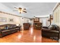 Cozy living room with hardwood floors, decorative fireplace, and ample seating at 4600 Beatties Ford Rd, Charlotte, NC 28216