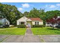 Charming yellow bungalow with red roof, well-maintained lawn, and lush green trees surrounding the property at 509 S Clay St, Gastonia, NC 28052