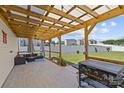 Inviting covered patio equipped with a grill, outdoor seating, and string lights perfect for relaxing at 5325 Merwyn Ave, Charlotte, NC 28215