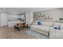 Bright living room featuring a comfortable sectional sofa, hardwood floors, and stylish decor at 5325 Merwyn Ave, Charlotte, NC 28215