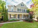 Charming two-story home with black shutters and a welcoming front porch perfect for relaxing at 533 Montgrove Nw Pl, Concord, NC 28027