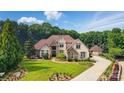 Expansive home with lush landscaping, circular driveway, and a separate garage or guest house at 581 Medora Ln, Fort Mill, SC 29708