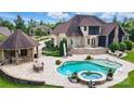 Resort-style backyard featuring a pool, spa, covered bar, patio and outdoor seating areas at 581 Medora Ln, Fort Mill, SC 29708