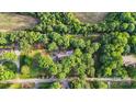 Expansive aerial view of a lush, tree-filled property with a house nestled in the trees at 603 Sunnybrook Dr, Monroe, NC 28110