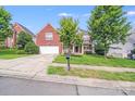 Attractive brick home with a two-car garage and a welcoming front lawn in a residential neighborhood at 6227 Castlecove Rd, Charlotte, NC 28278