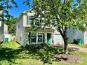 Charming two-story home with a well-maintained lawn, attached garage, and decorative green shutters at 7307 Mitzi Deborah Ln, Charlotte, NC 28269