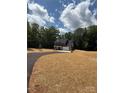 A lovely two-story home with a paved driveway and lush greenery providing a private setting at 910 Westminster Dr, Statesville, NC 28677