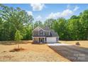 Charming two-story home features a blue exterior, attached garage, and a well-manicured lawn at 910 Westminster Dr, Statesville, NC 28677