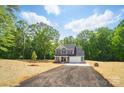 Beautiful home with a long driveway, lush greenery, and a well-maintained lawn at 910 Westminster Dr, Statesville, NC 28677