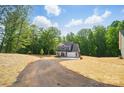 Beautiful home with a long driveway, lush greenery, and a well-maintained lawn at 910 Westminster Dr, Statesville, NC 28677