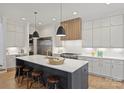 Bright kitchen with stainless steel appliances, an island with barstool seating, and modern pendant lighting at 922 Everett Pl, Charlotte, NC 28205