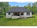 Back exterior view with covered patio and well-maintained yard at 9564 Regent Dr, Davidson, NC 28036