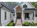 Inviting entryway with double doors, stone accents, and a covered porch at 9564 Regent Dr, Davidson, NC 28036