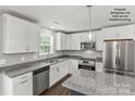 Modern kitchen featuring stainless steel appliances, granite countertops, and white cabinetry at Tbd Alf Hoover Rd # 4, Lincolnton, NC 28092