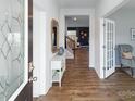 Inviting foyer with hardwood flooring, a decorative mirror, and views into other living spaces at 123 Rustling Waters Dr, Mooresville, NC 28117