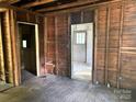 Unfinished living room featuring exposed wood framing and flooring at 126 N Kendall St, Norwood, NC 28128
