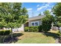 Well-kept home featuring a lush green lawn, mature trees, manicured shrubs and vinyl siding at 12792 Clydesdale Dr, Midland, NC 28107
