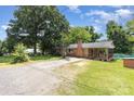Lovely single-story brick home with a sprawling lawn and covered porch area at 128 Paul Snipes Rd, Lancaster, SC 29720