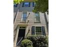 Two-story home featuring balcony access and dark shutters, bathed in natural light at 13838 Winmau Ln, Huntersville, NC 28078