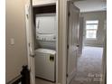 Convenient laundry closet featuring a stacked washer and dryer unit, optimizing space at 13838 Winmau Ln, Huntersville, NC 28078