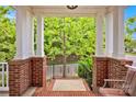 Inviting front porch with classic brick columns and a charming view of the outdoors at 14940 Carbert Ln, Huntersville, NC 28078