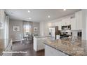 Bright kitchen with granite countertops, stainless steel appliances, and a cozy dining area at 155 Rustling Waters Dr, Mooresville, NC 28117