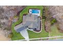 Aerial view of the home, in-ground pool, jacuzzi, walkway, and lush greenery at 17416 Gillican Overlook Rd, Davidson, NC 28036