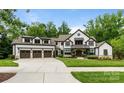 Charming two-story home with a three-car garage and a lush green lawn at 17416 Gillican Overlook Rd, Davidson, NC 28036
