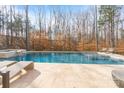 Beautiful in-ground pool and stone patio with lounge chairs at 17416 Gillican Overlook Rd, Davidson, NC 28036