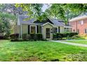 Quaint home featuring a lush green lawn and charming architectural details at 1809 The Plaza None, Charlotte, NC 28205