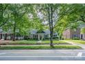 Charming house with mature trees, green lawn, and a well-maintained yard at 1809 The Plaza None, Charlotte, NC 28205