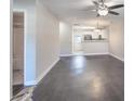Spacious living room with a modern ceiling fan, and neutral walls, leading into the kitchen and bathroom at 2153 Pavilion Ct, Rock Hill, SC 29732