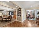 An open-concept floor plan with formal dining areas showcasing hardwood floors and elegant furnishings at 2627 Hampton Ave, Charlotte, NC 28207