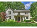 Inviting white brick home with a well-manicured lawn and beautiful, mature landscaping at 2627 Hampton Ave, Charlotte, NC 28207