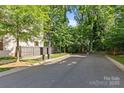 Street view featuring mature trees and a basketball hoop down the street from the property at 2906 Hillside Springs Dr, Charlotte, NC 28209