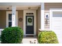 Welcoming front entrance with a wreath on the door and well-manicured landscaping, creating great curb appeal at 3664 Privette Rd, Matthews, NC 28104